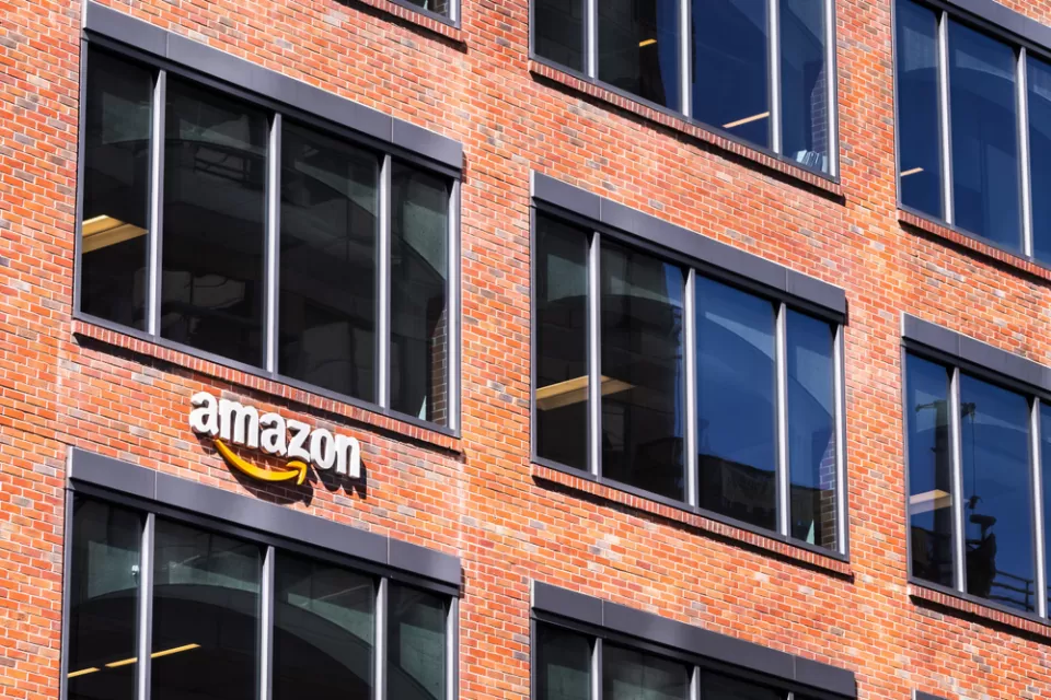 An Amazon sign adorns a brick building that implies an urban location.